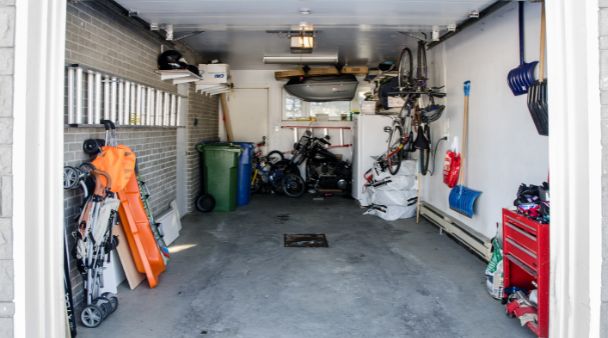 a home's garage with storage and bikes inside